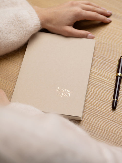 Kawowy dziennik Jaśnie Myśli leżący na stole